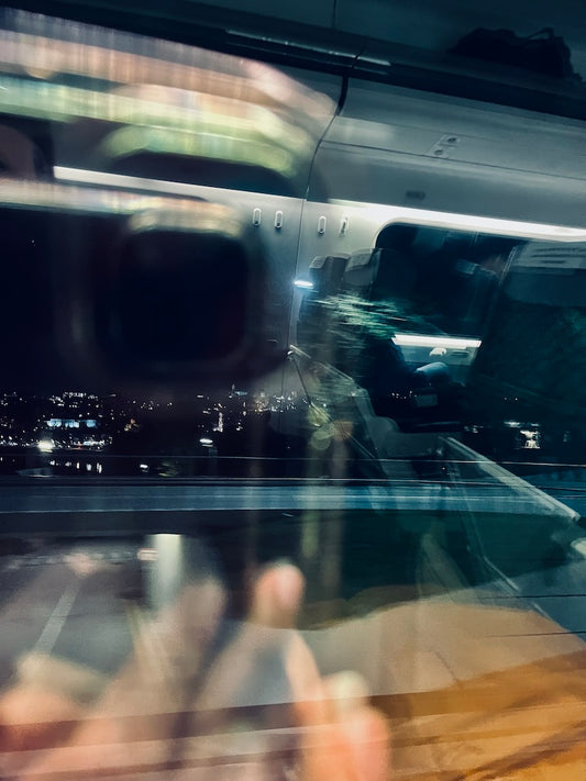 image: photo from a train window of Porto's night scene