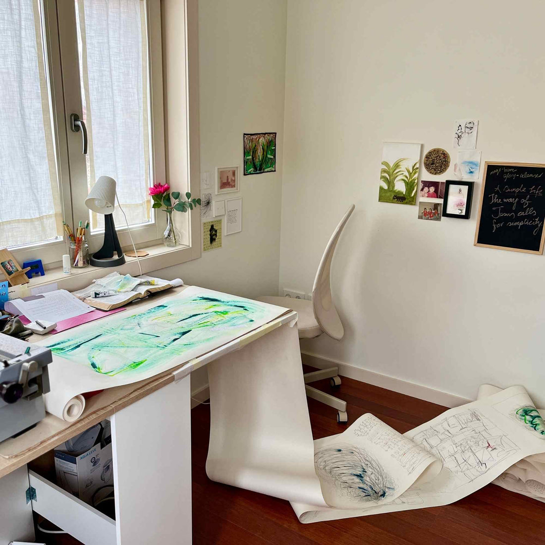 image: a long roll of drawing paper with abstract drawing