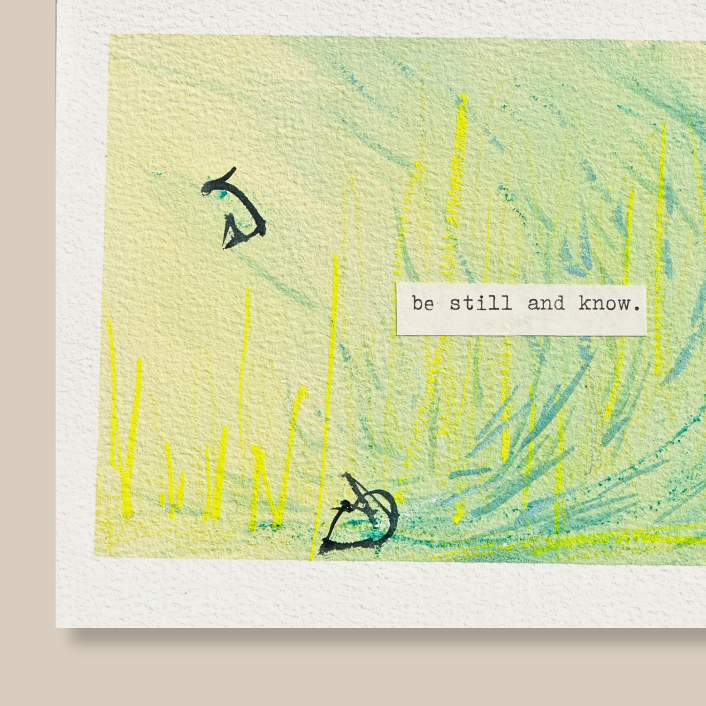 Close up of abstract mixed media painting with typewritten text 'be still and know' on a beige background