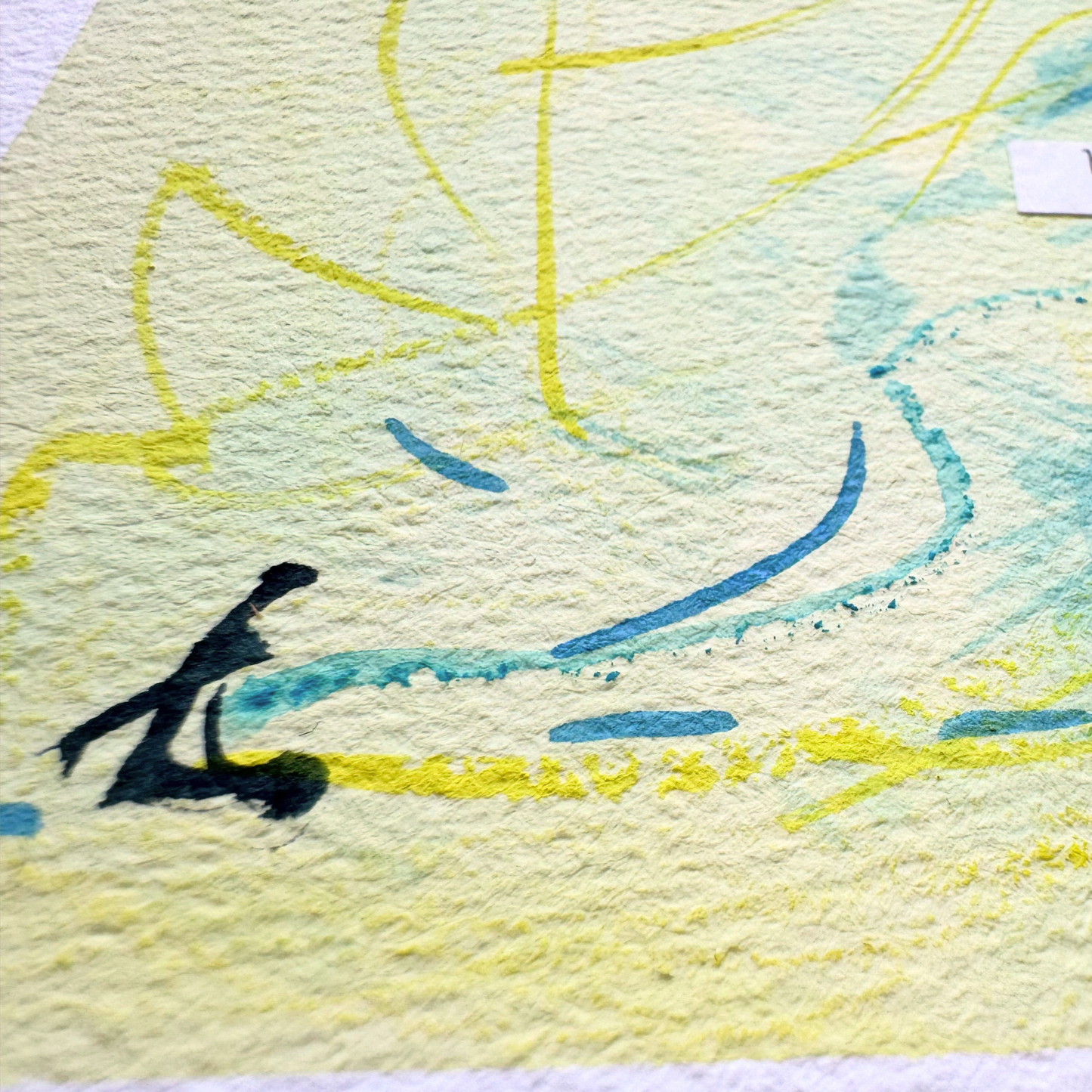 Close up of abstract mixed media painting on textured cold pressed watercolour paper