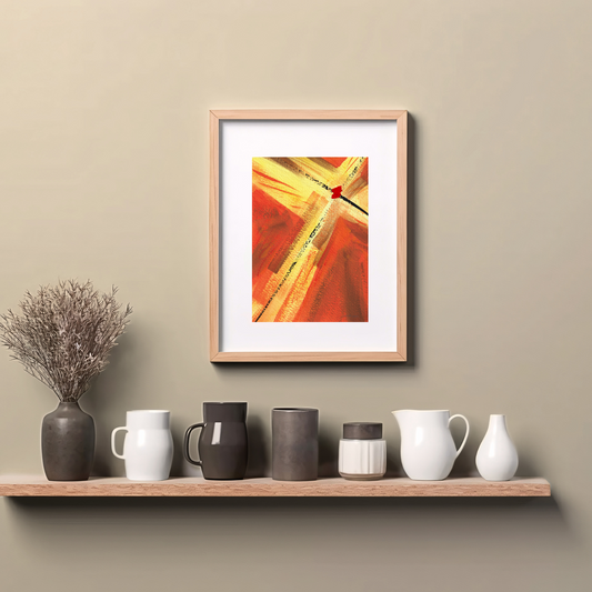 Framed reddish orange and golden yellow abstract painting art print with expressive brushstrokes with a dot of red paint, spiritual modern art print, hanging on wall above a wooden counter top.