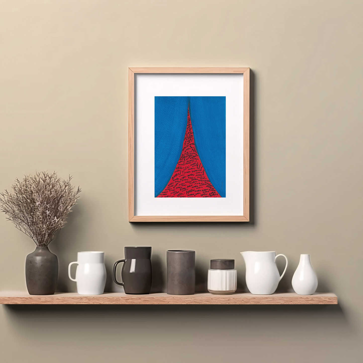 Framed red and blue abstract art print with the handwritten words’ AMEN' in thin black lines, hanging on wall above a wooden counter top.