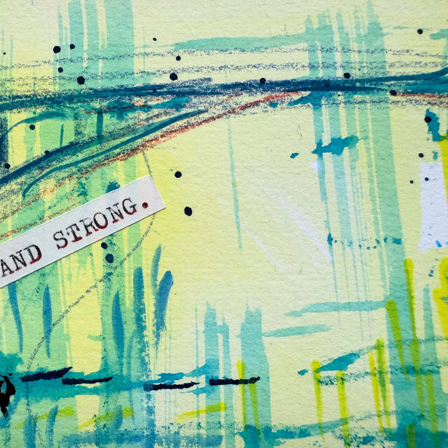 Close up of abstract painting with abstract landscape and 'Stand Strong' typewritten text