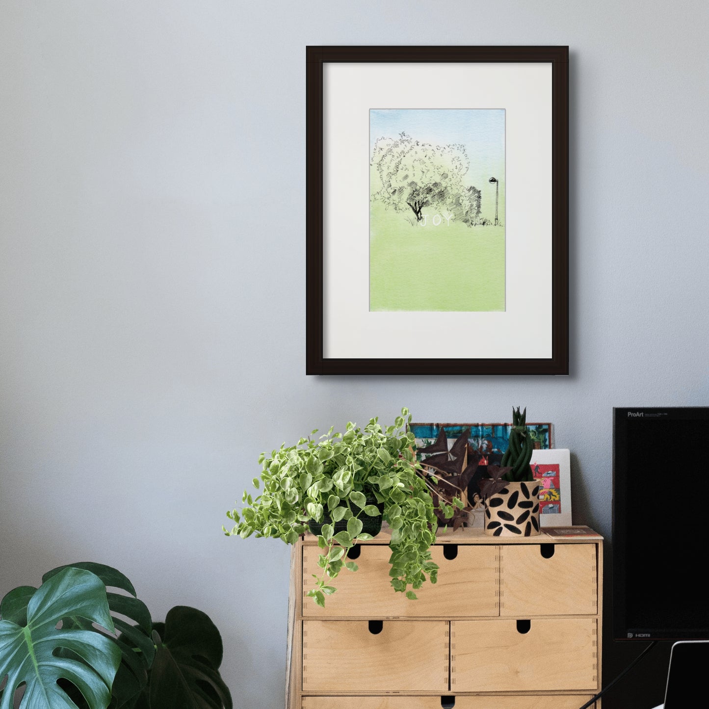 Image: Line drawing with watercolour giclée art print with black frame and cream colour mat of a peaceful, green nook at Parque da Cidade do Porto (Porto City Park).
