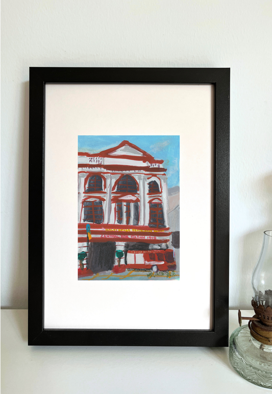 Framed painting of Penang Central Fire station with a fire truck in front, featuring red, white, and dark brown colours against blue sky.
