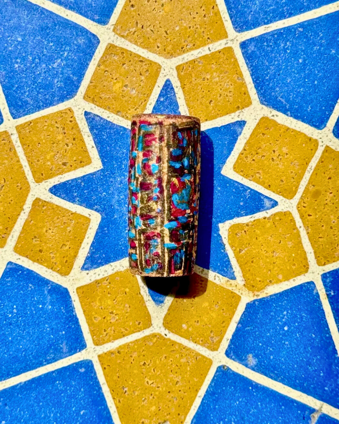 Intuitive abstract painting on Fita Preta wine cork, acrylic gouache & pen on a Portuguese blue and yellow tiled surface by Melinda Yeoh art