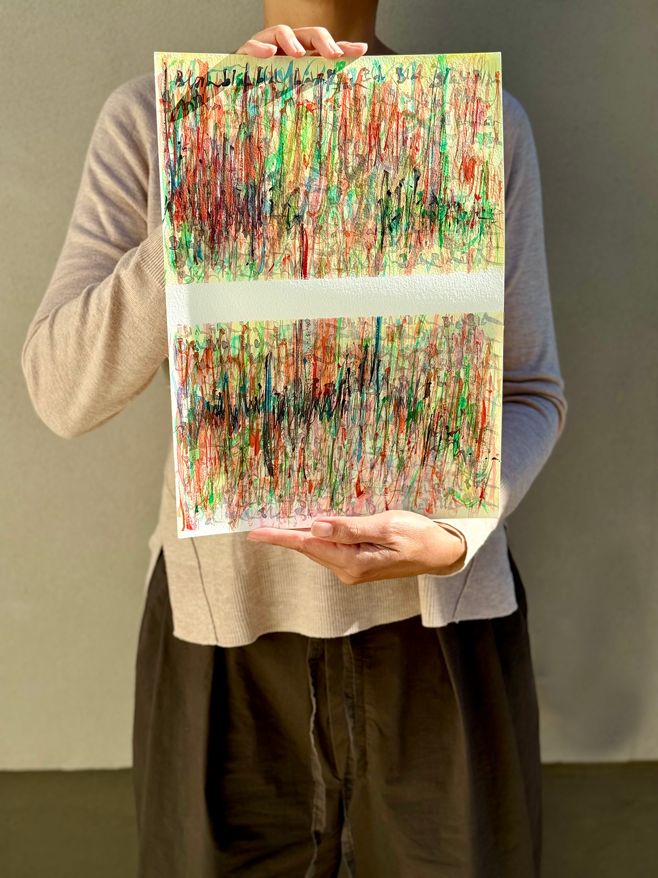 image: artist holding an abstract painting