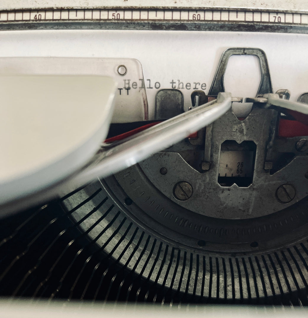 image: close up of typewriter with the typed words Hello there. Photo by Melinda Yeoh