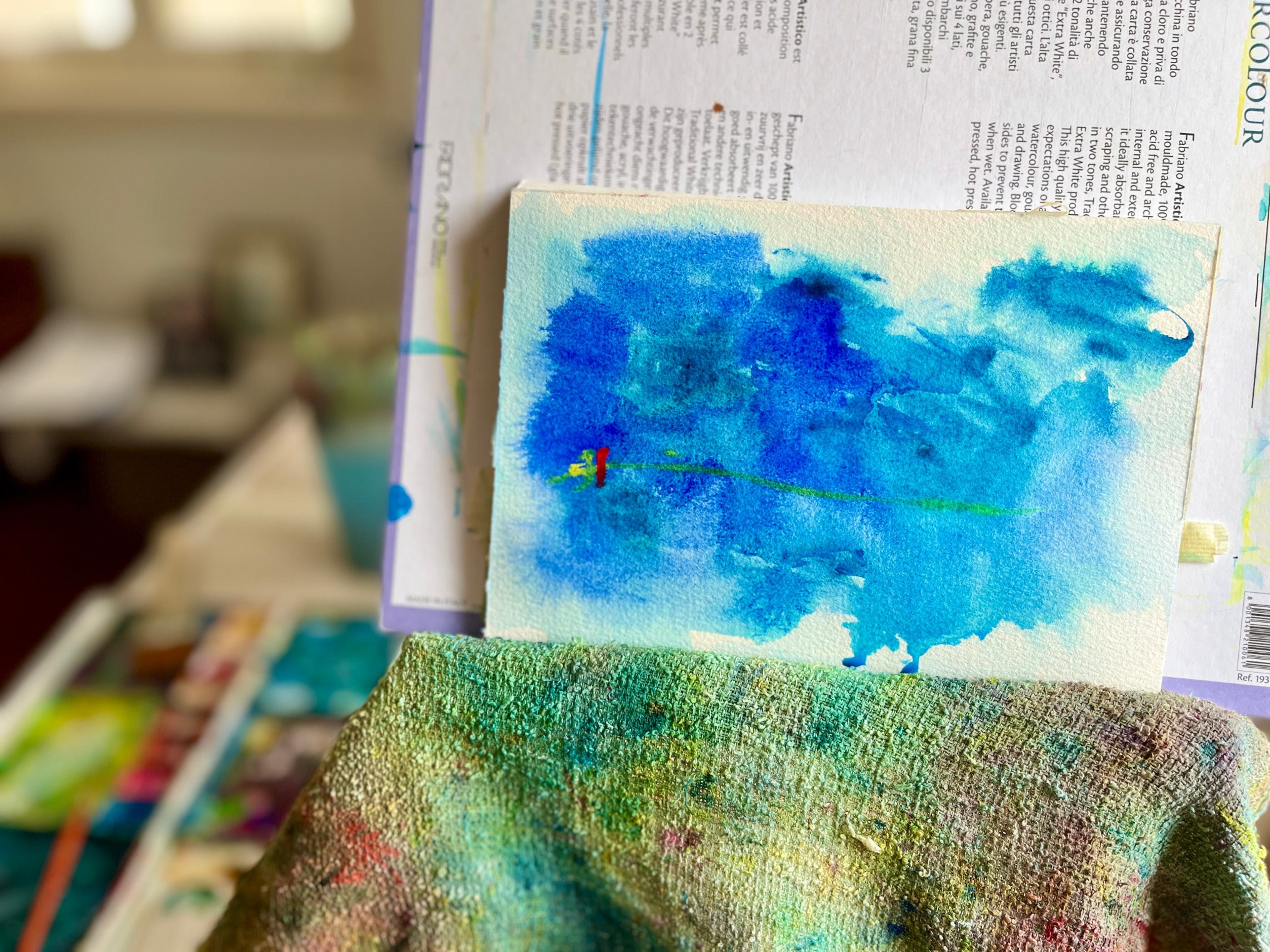 Abstract acrylic gouache painting on a watercolour block propped on an easel with a blurred background by Melinda Yeoh Art